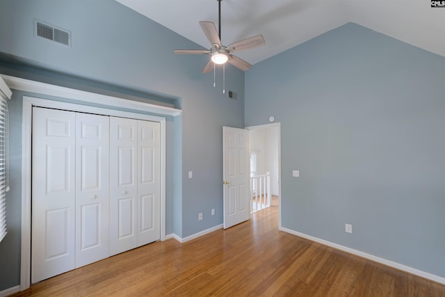 920 Woodrow St Unit 1, Columbia, SC 29205 - unfurnished bedroom with high vaulted ceiling, wood finished floors, a closet, baseboards, and ceiling fan