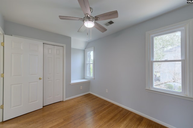 920 Woodrow St Unit 1, Columbia, SC 29205 - unfurnished bedroom with light wood-type flooring, baseboards, a closet, and a ceiling fan