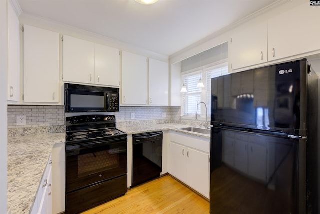 920 Woodrow St Unit 1, Columbia, SC 29205 - kitchen with black appliances, a sink, white cabinets, and tasteful backsplash