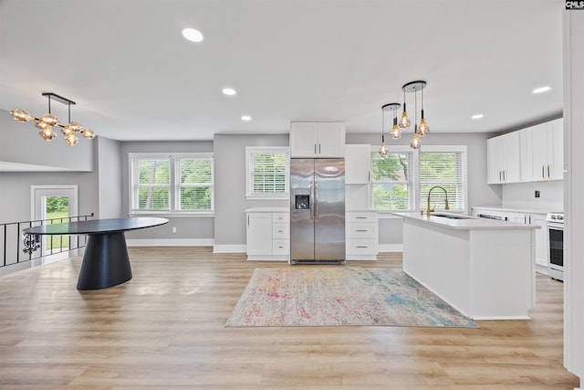107 Fifeshire Dr, Columbia, SC 29212 - kitchen featuring stainless steel fridge, a sink, white cabinetry, light countertops, and healthy amount of natural light