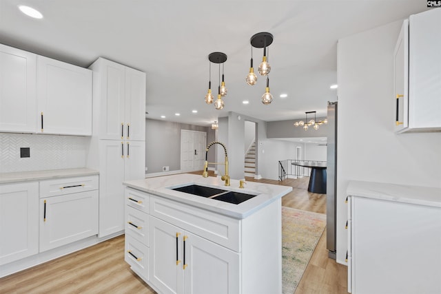 107 Fifeshire Dr, Columbia, SC 29212 - kitchen featuring a sink, recessed lighting, light wood finished floors, white cabinets, and tasteful backsplash