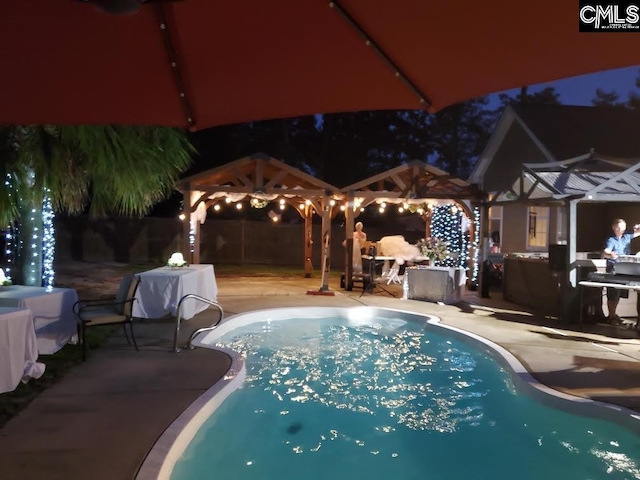 28 Calabash Ln, Elgin, SC 29045 - pool at night with a gazebo, a patio, and an outdoor pool