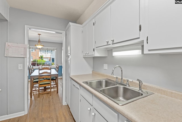 1908 Grays Inn Rd, Columbia, SC 29210 - kitchen featuring a sink, white dishwasher, light wood-style floors, white cabinetry, and light countertops