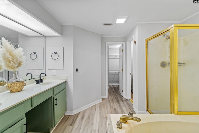 1850 Atlantic Dr, Columbia, SC 29210 - bathroom featuring wood finished floors, a shower stall, double vanity, a spacious closet, and ornamental molding