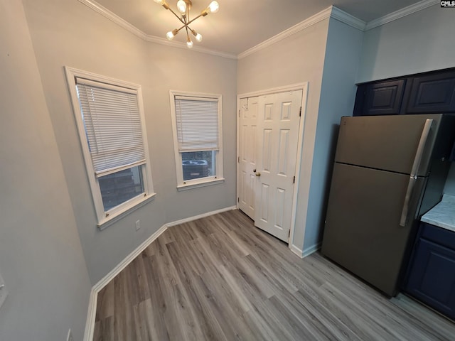 1850 Atlantic Dr, Columbia, SC 29210 - kitchen with freestanding refrigerator, a chandelier, light wood-style flooring, crown molding, and baseboards