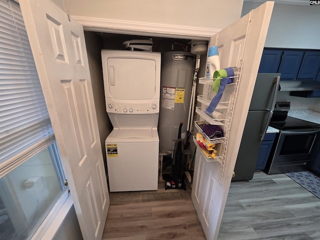 1850 Atlantic Dr, Columbia, SC 29210 - laundry area featuring stacked washing machine and dryer, electric water heater, and wood finished floors