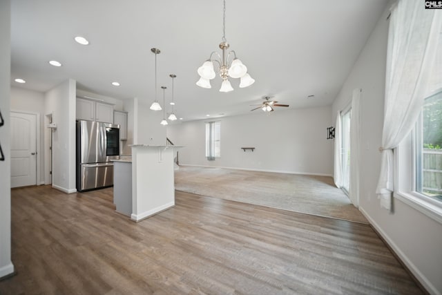 514 Red Taffy Way, Lexington, SC 29073 - kitchen featuring freestanding refrigerator, a kitchen breakfast bar, a chandelier, recessed lighting, and decorative light fixtures
