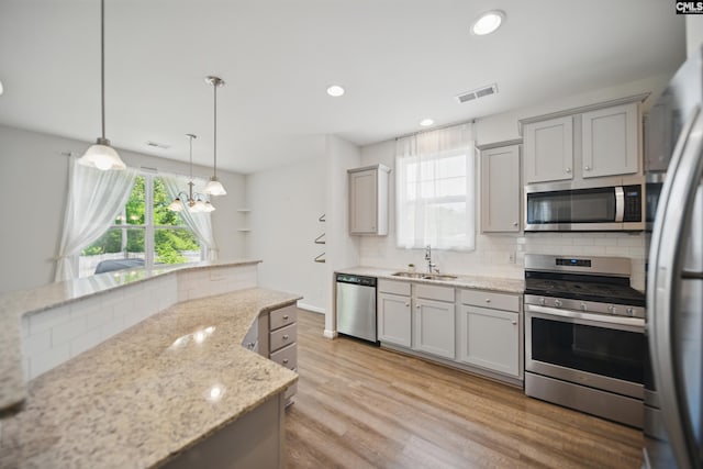 514 Red Taffy Way, Lexington, SC 29073 - kitchen with appliances with stainless steel finishes, a sink, backsplash, light wood-type flooring, and recessed lighting