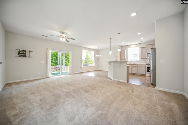 514 Red Taffy Way, Lexington, SC 29073 - unfurnished living room featuring light colored carpet, ceiling fan, plenty of natural light, recessed lighting, and baseboards