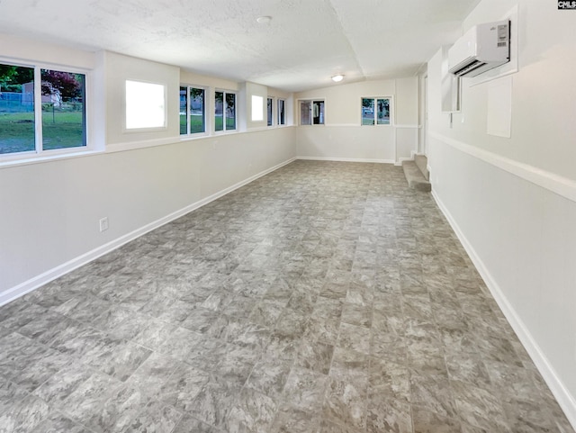 2540 Chatsworth Rd, Columbia, SC 29223 - below grade area featuring an AC wall unit, baseboards, and a textured ceiling