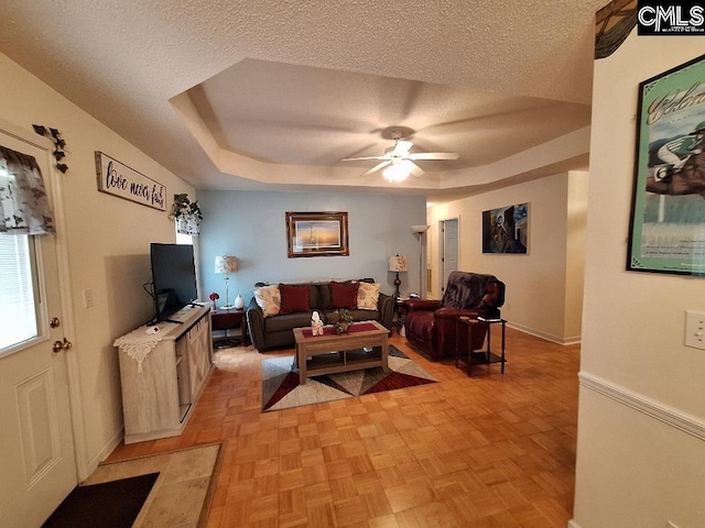 2279TICKLEHIL Tickle Hill Rd, Camden, SC 29020 - living area featuring a ceiling fan, a textured ceiling, a tray ceiling, and baseboards
