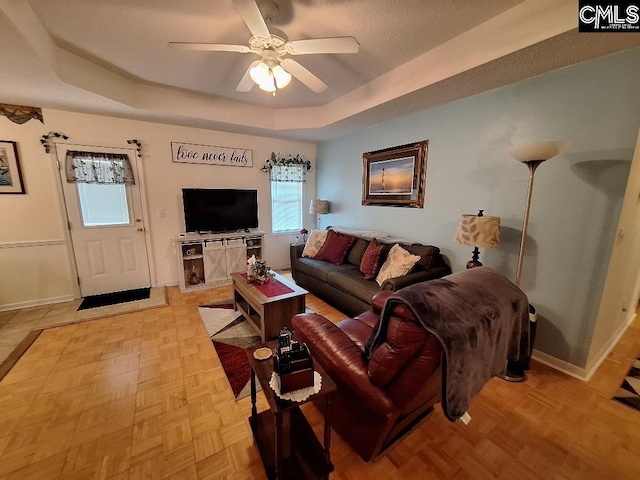 2279TICKLEHIL Tickle Hill Rd, Camden, SC 29020 - living room featuring a tray ceiling, a ceiling fan, and baseboards