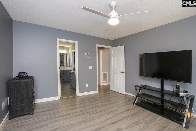 173 Rosewood Ln, Lexington, SC 29072 - living area with light wood-style floors, ceiling fan, baseboards, and a textured ceiling