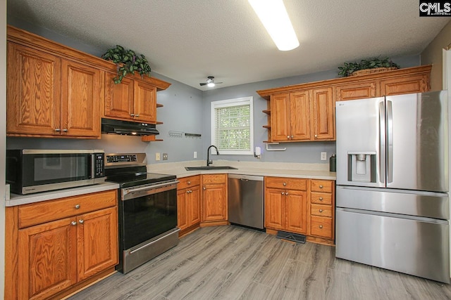 173 Rosewood Ln, Lexington, SC 29072 - kitchen with appliances with stainless steel finishes, open shelves, a sink, under cabinet range hood, and brown cabinets
