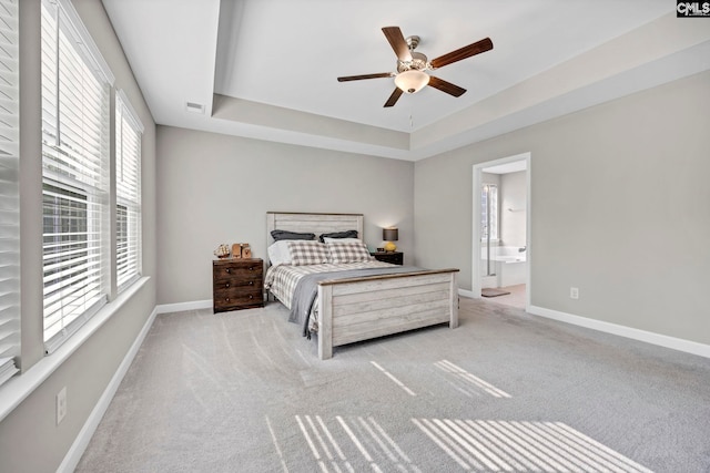 556 Harbour Pointe Dr, Columbia, SC 29229 - bedroom featuring multiple windows, a tray ceiling, carpet floors, and baseboards