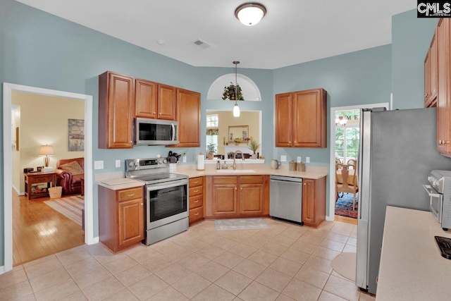 121 Stonemont Dr, Irmo, SC 29063 - kitchen featuring stainless steel appliances, a sink, light countertops, and plenty of natural light