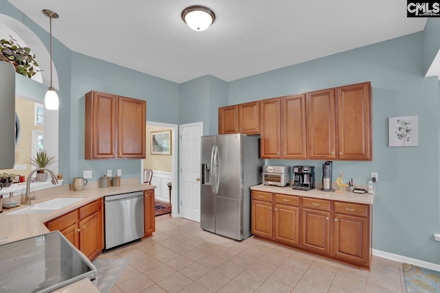 121 Stonemont Dr, Irmo, SC 29063 - kitchen featuring stainless steel appliances, a sink, brown cabinetry, and light countertops