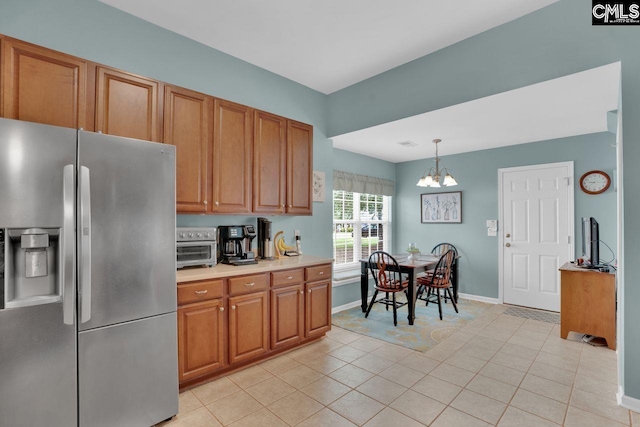 121 Stonemont Dr, Irmo, SC 29063 - kitchen with stainless steel fridge with ice dispenser, a chandelier, brown cabinetry, and light countertops