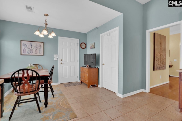 121 Stonemont Dr, Irmo, SC 29063 - dining area featuring a chandelier, light tile patterned floors, and baseboards