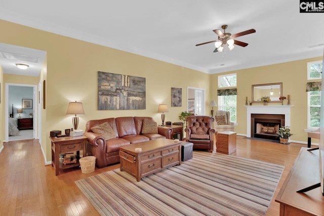 121 Stonemont Dr, Irmo, SC 29063 - living room featuring healthy amount of natural light, light wood-style flooring, ceiling fan, and a fireplace with flush hearth