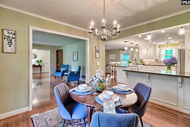 1108 Tarrytown Ln, West Columbia, SC 29170 - dining space with a chandelier, ornamental molding, wood finished floors, and baseboards