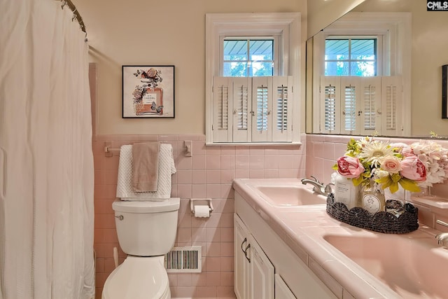 1108 Tarrytown Ln, West Columbia, SC 29170 - full bath with toilet, double vanity, tile walls, a wainscoted wall, and a shower with curtain