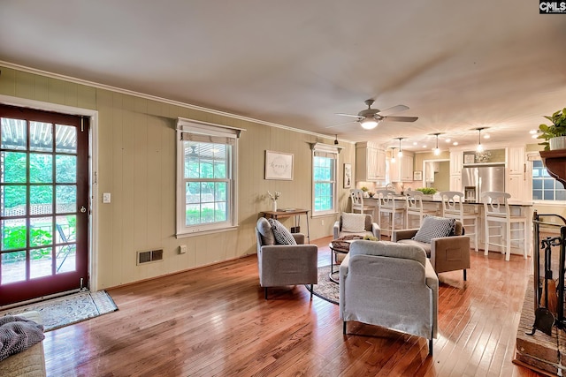 1108 Tarrytown Ln, West Columbia, SC 29170 - living room with crown molding, a ceiling fan, and light wood-style flooring