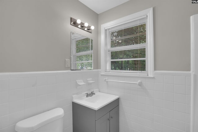 2136 Windale Dr, Columbia, SC 29223 - bathroom with vanity, tile walls, toilet, and a wainscoted wall