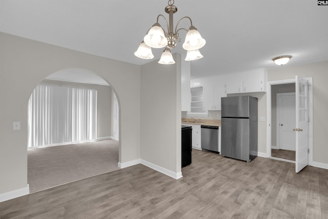 2136 Windale Dr, Columbia, SC 29223 - kitchen with stainless steel appliances, arched walkways, a sink, white cabinetry, and light wood-style flooring