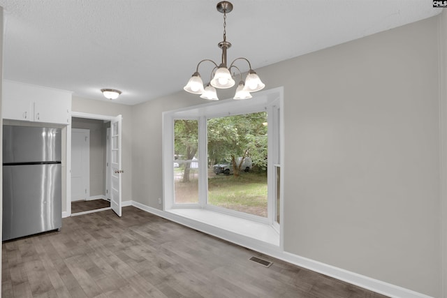 2136 Windale Dr, Columbia, SC 29223 - unfurnished dining area with wood finished floors, a chandelier, and baseboards