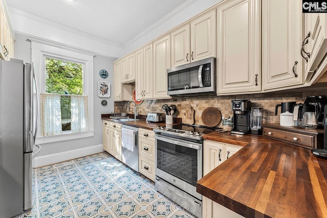 2909 Columbia Ave, Columbia, SC 29201 - kitchen with wood counters, appliances with stainless steel finishes, a sink, backsplash, and ornamental molding