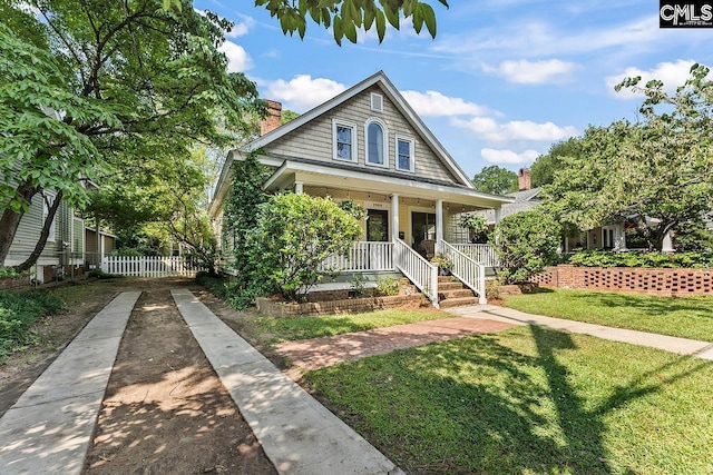 2909 Columbia Ave, Columbia, SC 29201 - bungalow with a porch, a chimney, and concrete driveway