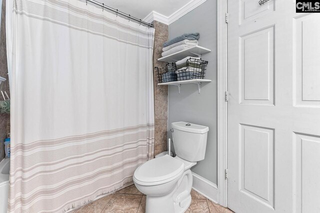 2909 Columbia Ave, Columbia, SC 29201 - bathroom featuring toilet, ornamental molding, tile patterned floors, curtained shower, and baseboards