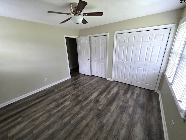 804 Dogwood St, Cayce, SC 29033 - unfurnished bedroom featuring baseboards, dark wood-type flooring, multiple closets, and ceiling fan