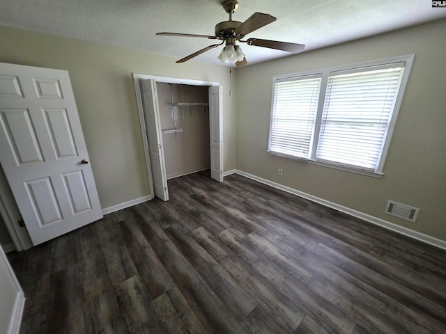 804 Dogwood St, Cayce, SC 29033 - unfurnished bedroom with a closet, dark wood-style floors, baseboards, a ceiling fan, and a textured ceiling