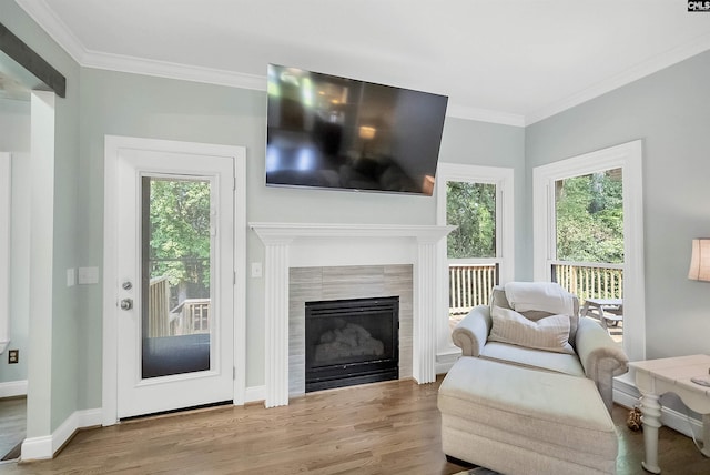 315 Poindexter Ln, Lexington, SC 29072 - living room with wood finished floors, crown molding, a tiled fireplace, and baseboards