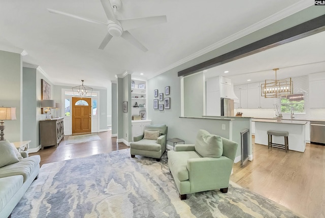 315 Poindexter Ln, Lexington, SC 29072 - living room with a chandelier, light wood-style flooring, ornamental molding, a ceiling fan, and baseboards