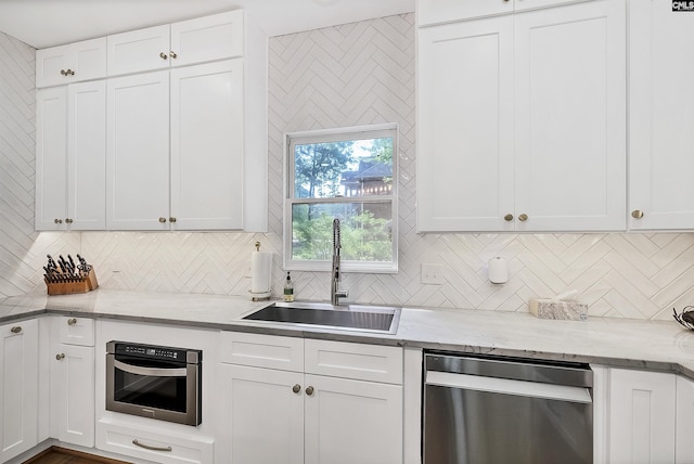 315 Poindexter Ln, Lexington, SC 29072 - kitchen with a sink, stainless steel appliances, tasteful backsplash, and white cabinetry