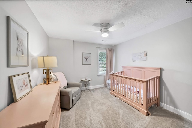 315 Poindexter Ln, Lexington, SC 29072 - bedroom with light colored carpet, baseboards, a crib, a ceiling fan, and a textured ceiling