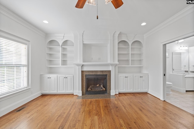 104 Eastshore Dr, Lexington, SC 29072 - unfurnished living room featuring built in shelves, a ceiling fan, a fireplace with flush hearth, crown molding, and baseboards