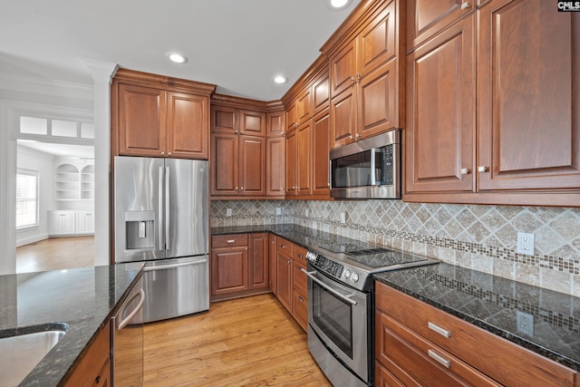 104 Eastshore Dr, Lexington, SC 29072 - kitchen featuring appliances with stainless steel finishes, recessed lighting, ornamental molding, light wood-style flooring, and brown cabinetry