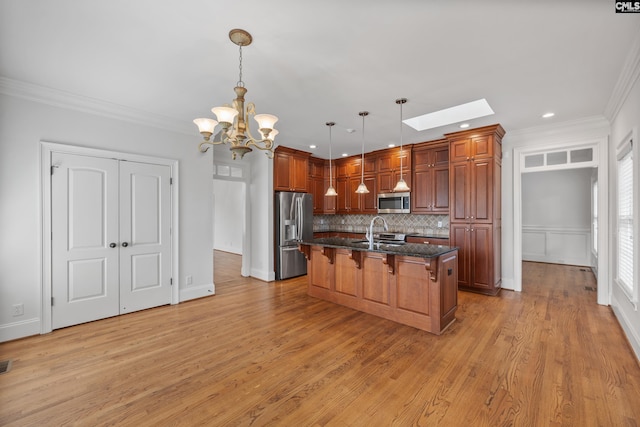 104 Eastshore Dr, Lexington, SC 29072 - kitchen with stainless steel appliances, a breakfast bar area, a sink, backsplash, and a chandelier