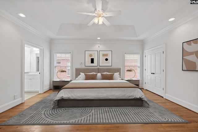 104 Eastshore Dr, Lexington, SC 29072 - bedroom featuring a raised ceiling, light wood finished floors, baseboards, ensuite bathroom, and ornamental molding