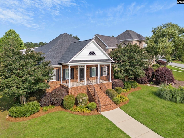 104 Eastshore Dr, Lexington, SC 29072 - greek revival inspired property with covered porch, stairs, brick siding, a front lawn, and roof with shingles