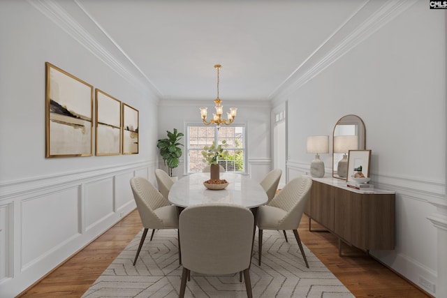 104 Eastshore Dr, Lexington, SC 29072 - dining room with a chandelier, a decorative wall, ornamental molding, light wood finished floors, and a wainscoted wall