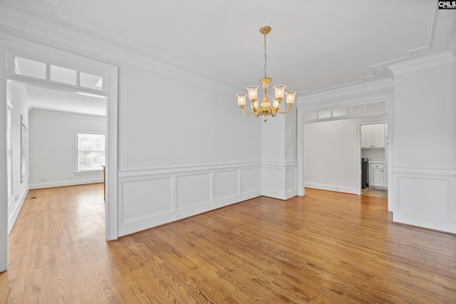 104 Eastshore Dr, Lexington, SC 29072 - unfurnished dining area with crown molding, a chandelier, light wood-style floors, a decorative wall, and wainscoting
