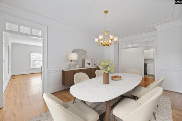 104 Eastshore Dr, Lexington, SC 29072 - dining space featuring crown molding, a chandelier, light wood-type flooring, a decorative wall, and a wainscoted wall