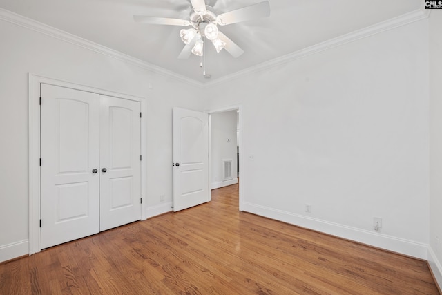 104 Eastshore Dr, Lexington, SC 29072 - unfurnished bedroom with baseboards, crown molding, wood finished floors, a closet, and ceiling fan