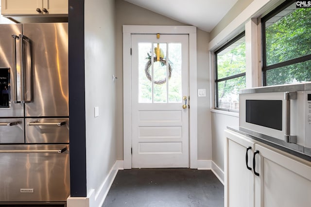 2808 River Dr, Columbia, SC 29201 - doorway to outside featuring plenty of natural light, baseboards, vaulted ceiling, and finished concrete flooring