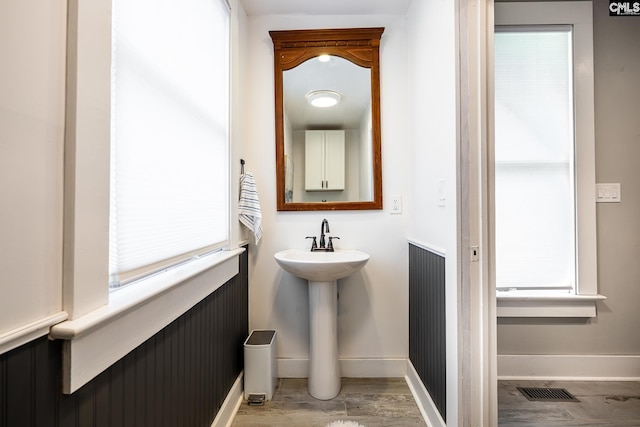 2808 River Dr, Columbia, SC 29201 - bathroom featuring wood finished floors, a sink, and baseboards